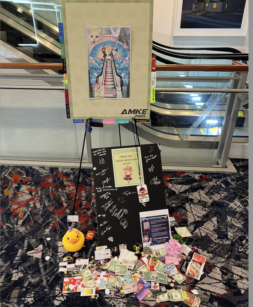 A sign that says "Polkalator Memorial" surrounded by dollar bills and a signed note from staff. 